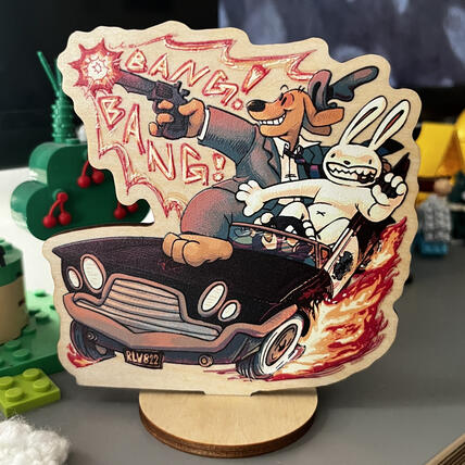A wood standee of Sam and Max driving the DeSoto and shooting.