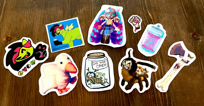 A spread of matte stickers with varying subjects. Some are illustrated and some are 3D modeled.